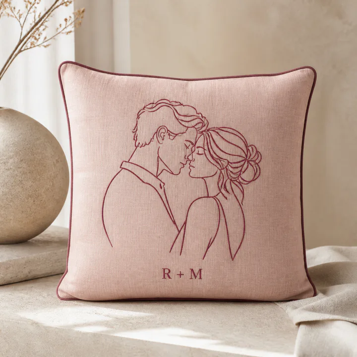 Blush cushion with a personalized couple line illustration