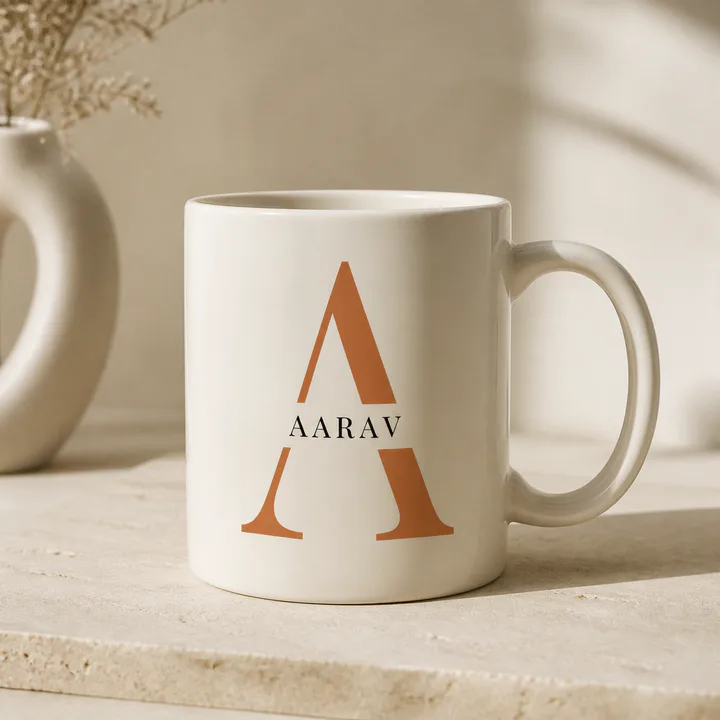 Ivory mug with a large terracotta initial and personalized name